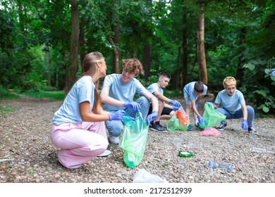 Young Responsible People Doing Community Charity Work In The Park. Group Of People, Cleaning Together In Public Park, Saving The Environment.