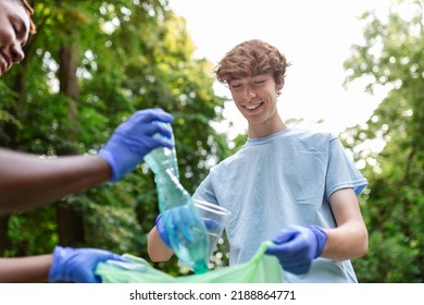 Young Responsible People Doing Community Charity Work In The Park. Group Of People, Cleaning Together In Public Park, Saving The Environment.