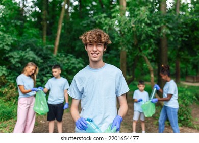 Young Responsible People Doing Community Charity Work In The Park. Group Of People, Cleaning Together In Public Park, Saving The Environment.