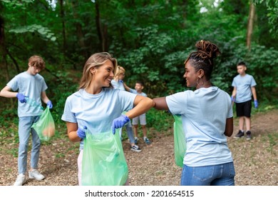 Young Responsible People Doing Community Charity Work In The Park. Group Of People, Cleaning Together In Public Park, Saving The Environment.