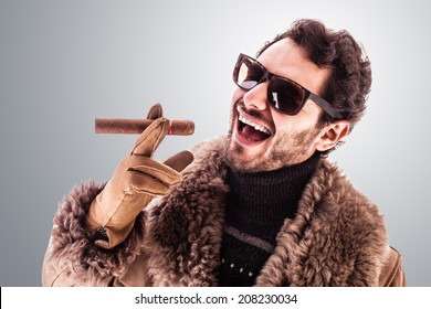 A Young And Rich Man Wearing A Sheepskin Coat Isolated Over A White Background Holding A Cigar