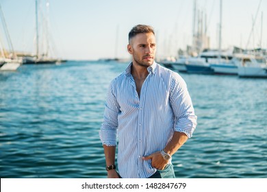 Young Rich Man At Yacht Club. Businessman Is Relaxing In The Gulf With Seaview And Luxury Ships