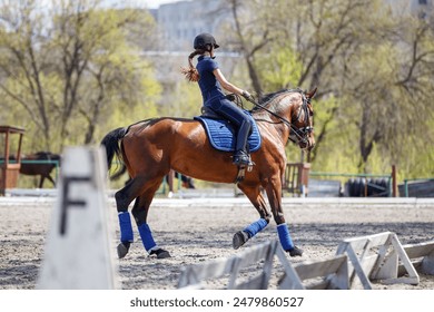 Young rider girl riding horse during dressage training in spring - Powered by Shutterstock