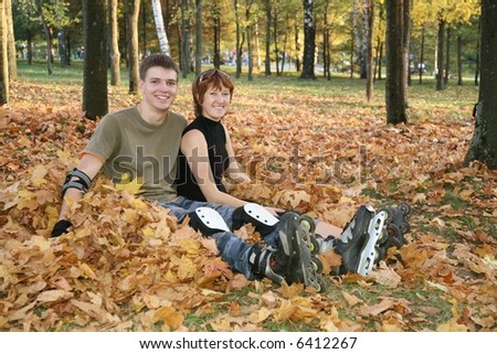 young roller couple sit in park