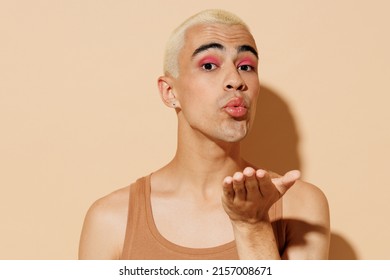 Young Romantic Boyfriend Lover Trendy Blond Latin Gay Man 20s With Make Up Wear Beige Tank Shirt Blow Air Kiss Isolated On Plain Light Ocher Background Studio Portrait People Lgbt Lifestyle Concept