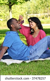 Young Romantic Couple Having Picnic In Summer Park