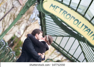 Young romantic couple kissing near metro station in Paris - Powered by Shutterstock