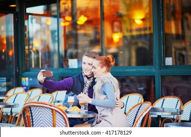 Young Romantic Couple Taking Selfie In Cafe In Paris, France