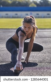 Young Runner Fit Woman Streching Before Exercises Outdoors. Athletic Female Strech After Workout Outside. Sport And People Concept.