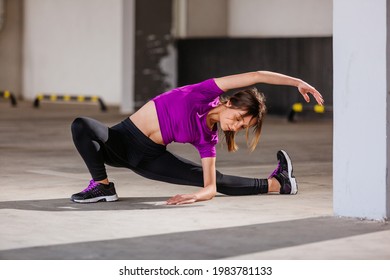 Young Runner Fit Woman Streching Before Exercises Outdoors. Athletic Female Strech After Workout Outside. Sport And People Concept.