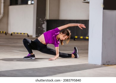 Young Runner Fit Woman Streching Before Exercises Outdoors. Athletic Female Strech After Workout Outside. Sport And People Concept.