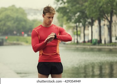 Young Running Man Looking At His Heart Rate Monitor Sports Smart Watch.