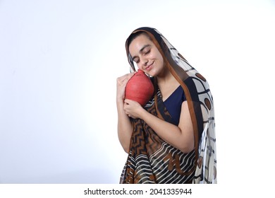 Young Rural Indian Bald Widow Saving Money Holding A Piggy Bank And Wearing A Saree Portraying Various Expressions Of The Widow Life. She Is Confident And Portraying Savings Concept.