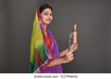 Young Rural Woman Holding Rolling Pin 