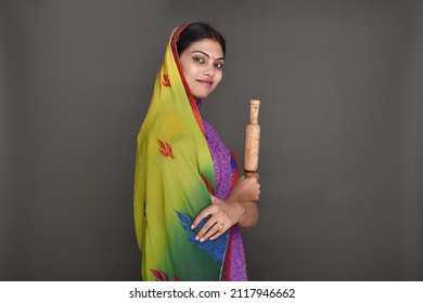 Young Rural Woman Holding Rolling Pin 