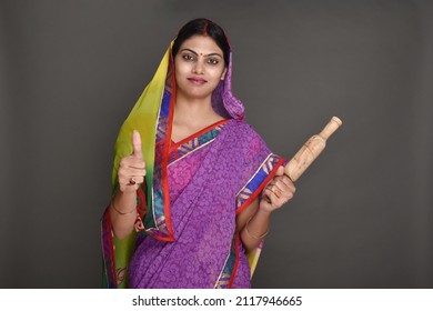 Young Rural Woman Holding Rolling Pin 