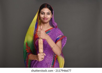 Young Rural Woman Holding Rolling Pin 