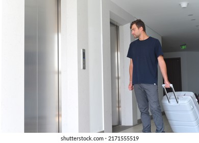 Young Russian Man Waiting For Lift With A Suitcase. Emigration Concept