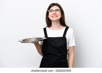 Young Russian Woman Chef With Tray Isolated On White Background Thinking An Idea While Looking Up