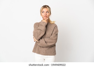 Young Russian Woman Isolated On White Background Thinking An Idea While Looking Up