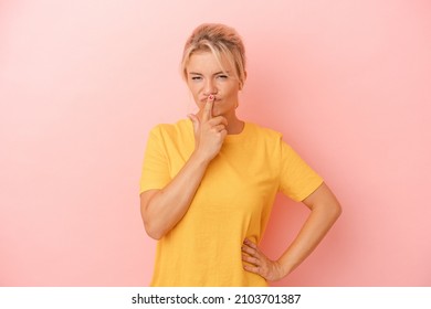 Young Russian Woman Isolated On Pink Background Thinking And Looking Up, Being Reflective, Contemplating, Having A Fantasy.