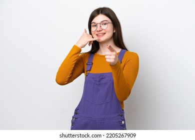 Young Russian Woman Isolated On Blue Background Making Phone Gesture And Pointing Front