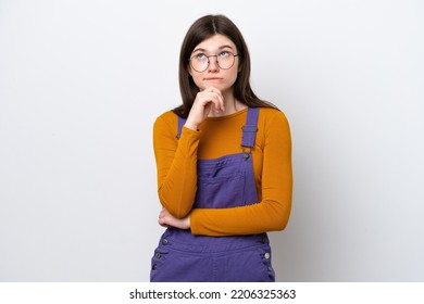 Young Russian Woman Isolated On Blue Background Having Doubts And Thinking