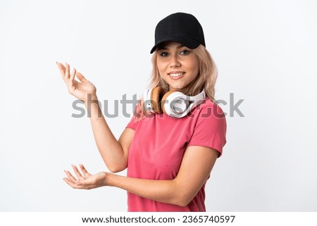 Young Russian woman listening music isolated on white background extending hands to the side for inviting to come