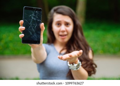 Young Sad Adult Woman Showing Cracked Phone