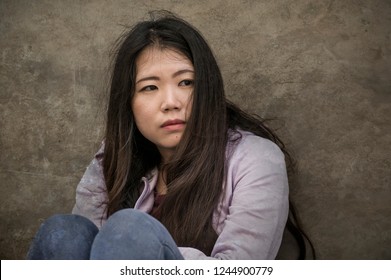 Young Sad And Depressed Asian American Student Woman Or Bullied Teenager Sitting Outdoors On Street Staircase Overwhelmed And Anxious Feeling Desperate Suffering Depression Problem 