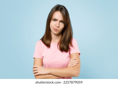 Young sad disappointed displeased caucasian woman 20s wear pink t-shirt look camera hold hands crossed folded isolated on pastel plain light blue background studio portrait. People lifestyle concept - Shutterstock ID 2257879059