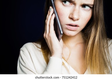 Young Sad Girl In A White Blouse Talking On The Phone