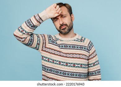 Young Sad Tired Exhausted Sick Ill Weary Caucasian Man 30s He Wear Sweater Hand On Forehead Suffer From Headache Isolated On Plain Pastel Light Blue Cyan Background Studio. People Lifestyle Concept