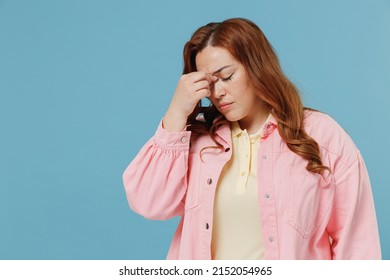 Young Sad Tired Sick Redhead Chubby Overweight Woman 30s Wearing Pink Shirt Casual Clothes Keep Eyes Closed Rub Put Hand On Nose Head Isolated On Pastel Blue Background Studio People Lifestyle Concept