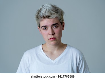 Young Sad Trans Teenager Boy Suffering From Depression Feeling Sad And Desperate. Depressed Transgender Teen In Distress In Mental Health, Depression And Gender Identity And Human Rights Concept.