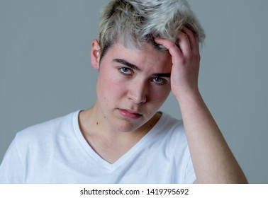 Young Sad Trans Teenager Boy Suffering From Depression Feeling Sad And Desperate. Depressed Transgender Teen In Distress In Mental Health, Depression And Gender Identity And Human Rights Concept.