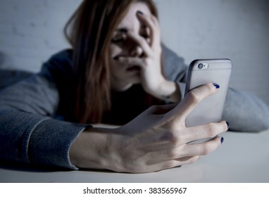 Young Sad Vulnerable Girl Using Mobile Phone Scared And Desperate Suffering Online Abuse Cyberbullying Being Stalked And Harassed In Teenager Cyber Bullying Concept