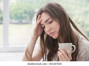 Young Sad Woman With Cup Of Coffee Or Tea. Stress, Depression, Illness Concept.