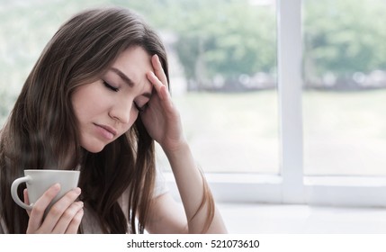 Young Sad Woman With Cup Of Coffee Or Tea. Stress, Depression, Illness Concept.