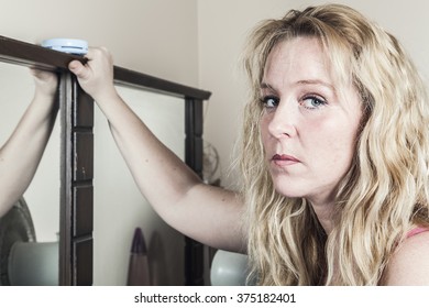 Young Sad Woman Looking In The Mirror 