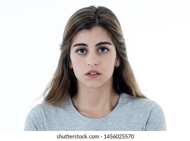 Young Sad Woman, Serious And Concerned, Looking Shocked And Worried Feeling Sorrow And Depressed. Close Up Portrait Isolated On White With Copy Space. In Facial Expressions And Emotions Concept.