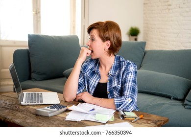 Young Sad Worried And Desperate Woman Banking And Accounting Home Monthly And Credit Card Expenses With Computer Laptop Doing  Paperwork In Living Cost Stress And Paying Bills Problem