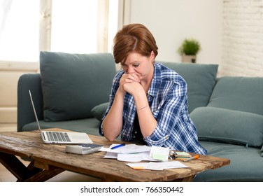 Young Sad Worried And Desperate Woman Banking And Accounting Home Monthly And Credit Card Expenses With Computer Laptop Doing  Paperwork In Living Cost Stress And Paying Bills Problem