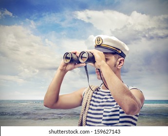 young sailor looks through binoculars - Shutterstock ID 159627143