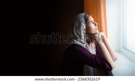 Young saint biblic shawl lone sad mood feel teen lady ask beg Lord Jesus Christ dark black home room text space. Pious adult face trust old hand bible wait love joy relax rest see day light white sky
