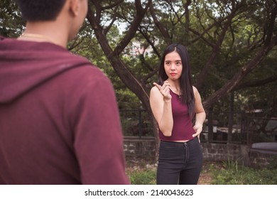 A Young Sarcastic Woman Pointing A Finger To Someone. Joking About Having A Relationship With The Person.