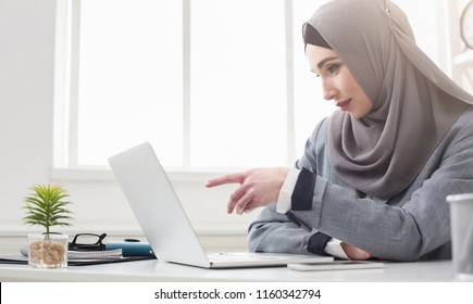 Young Saudi Business Woman Working In At Office, Pointing On Laptop, Copy Space