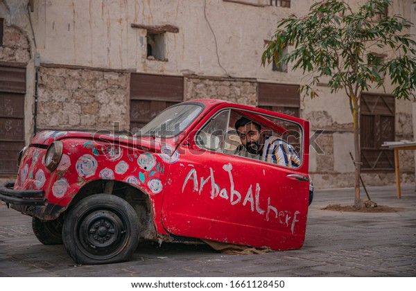 A young Saudi man
sits inside art work in the historical city of Jeddah, Jeddah,
Saudi Arabia 2020
