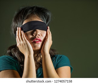 Young Scared And Blindfolded Asian Chinese Teenager Girl Lost And Confused Playing Dangerous Internet Viral Challenge Isolated On Dark Background Under Edgy And Dramatic Studio Light