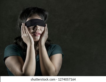 Young Scared And Blindfolded Asian Korean Teenager Girl Lost And Confused Playing Dangerous Internet Viral Challenge Isolated On Dark Background Under Edgy And Dramatic Studio Light